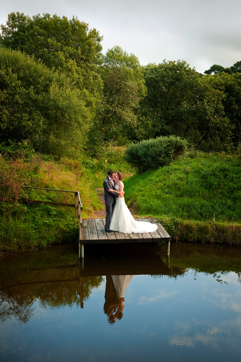 Bride-and-groom-Gellifawr-hotel-jetty-lake-reflections-Fishguard-wedding-photography