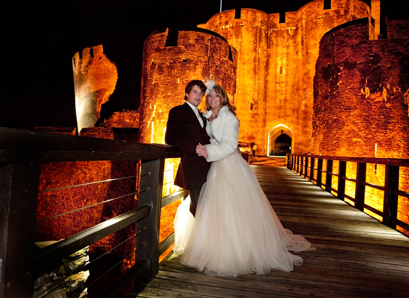 Winter-weddings-bride-groom-caerphilly-castle-floodlit-south-wales-winter-wedding-photography
